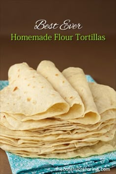 a stack of tortillas sitting on top of a blue napkin