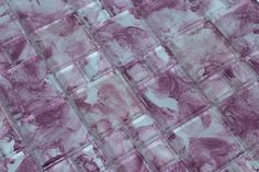 an abstract pattern made up of squares and rectangles in shades of pink, purple and white