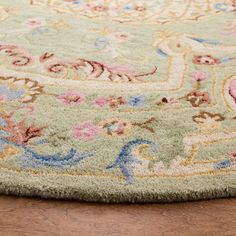 a close up of a rug on a wooden floor