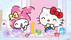 two hello kitty characters standing next to each other in front of a table full of food