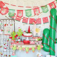 a christmas party with cactus decorations and desserts on the table in front of it