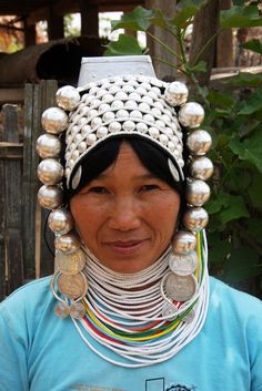 a woman wearing a headdress made out of beads and coins