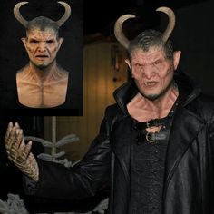 an image of a man with horns on his head and hands in front of him