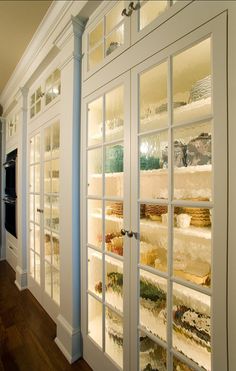 an image of a room with glass doors and shelves full of food on the wall