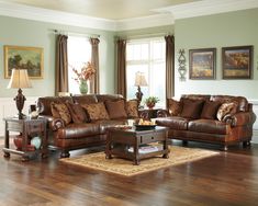 a living room filled with lots of brown furniture