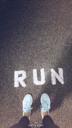 someone standing in front of the word run painted on the ground