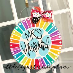 a colorful door hanger with the words mrs morgan on it and polka dot bows