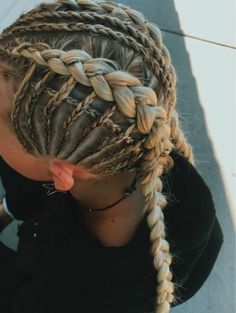 a woman with long blonde braids on her head and wearing a black t - shirt