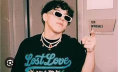 a young man wearing sunglasses and holding a cell phone in his right hand with the word lost love written on it