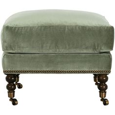 the foot stool is made from wood and has a light green velvet upholstered