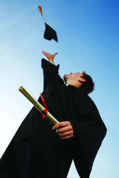 a graduate tossing his cap and gown in the air