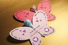 a paper butterfly with candy on it sitting on top of a table