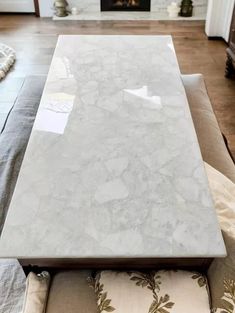 a white marble table sitting on top of a couch