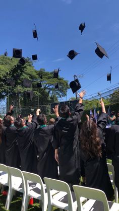 graduates throwing their caps in the air