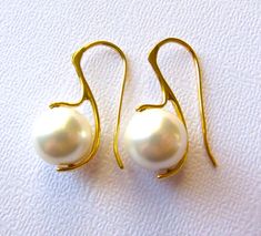 "These earrings are part of my new collection, focusing on modern sleek lines and organic natural components. These Tahitian shell pearls are unique, especially for their larger size, which is rare. The color is magnificent and has a lovely shimmer. The color of these in particular is very much sought after, a pure crisp white pearl. These would be a perfect elegant accessory for a modern bride, bridesmaid gifts, or maybe a holiday party? The uniqueness of these earrings is possible due to the 1 Classic Pearl Earrings, Tahitian Pearl Earrings, Pearl Earrings Gold, White Pearl Earrings, Pearl Jewels, White Pearl Earring, Jewelry Elegant, Gold Pearl Earrings, Tahitian Pearls