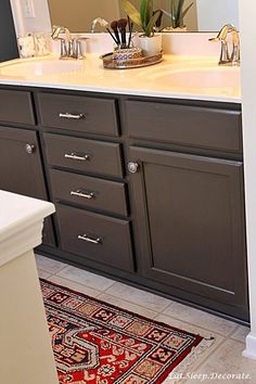 a bathroom with two sinks and a rug on the floor