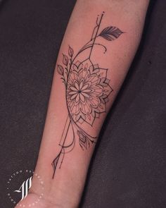 a woman's foot with a flower tattoo on the left side of her leg