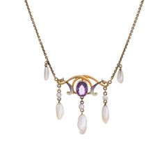 Stylish and finely detailed Art Nouveau drop necklace (circa 1900s to 1910s) crafted in 14 karat yellow gold.   One estimated .75 carat amethyst, 6mm x 3.5mm to 9mm x 3mm sawtooth pearls and enamel are set into the necklace. The amethyst is in very good condition and free of cracks or crisps. Note: slight chip to enamel.    The beautifully made Art Nouveau necklace highlights the faceted centre set oval amethyst with accenting purple and white enamel. Natural pearls are set in a fringe style to Formal Purple 14k Gold Necklace, Classic Amethyst Pendant Necklace, Art Nouveau Yellow Gold Gemstone Necklaces, Yellow Gold Oval Necklaces Art Nouveau Style, Art Nouveau Yellow Gold Oval Necklace, Antique Teardrop Yellow Gold Necklaces, Antique Yellow Gold Teardrop Necklaces, Art Nouveau 14k Gold Jewelry With Gemstones, Antique Yellow Gold Teardrop Necklace