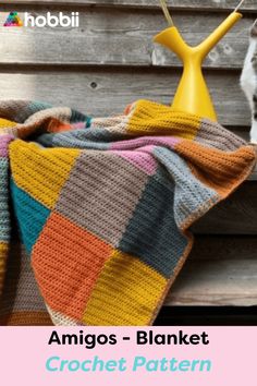 a cat sitting on a bench next to a blanket with the words amigos - blanket crochet pattern