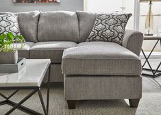 a living room with a gray couch and coffee table