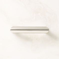 a metal handle on a white wall