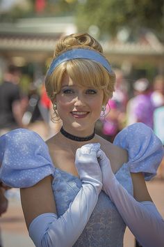 a woman dressed in blue is posing for the camera