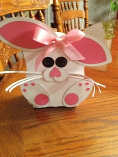 a paper bunny sitting on top of a wooden table