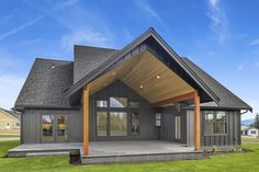 a large gray house with a covered porch