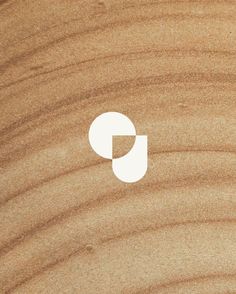 the letter g is made out of wood and has a white circle on top of it