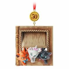 an ornament with two cats in a wooden frame and the number 50 on it