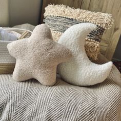 two star shaped pillows sitting on top of a bed