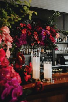 a bar with flowers and candles on the counter