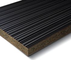 a close up view of the top of a black corrugated roof with wood slats