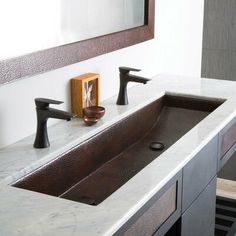 a bathroom sink with two faucets on the side and marble counter top next to it