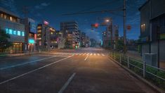 an empty city street at night with traffic lights and buildings in the background, all lit up