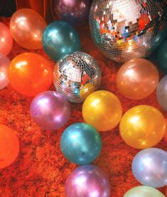 disco balls are scattered on the floor in front of mirrors