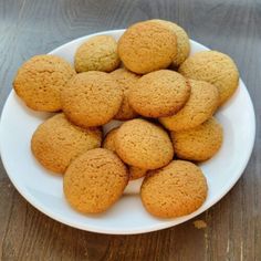 a white plate filled with cookies on top of a wooden table