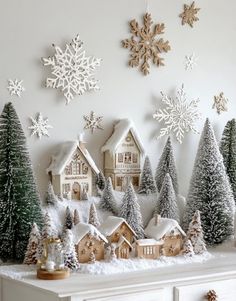 a white mantle topped with snow covered houses and trees