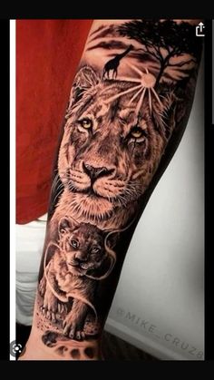 a man's arm with a tiger and lion tattoo on it