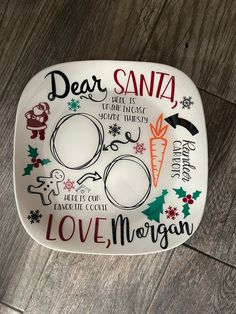 a white plate with christmas designs and words on the side that says, dear santa