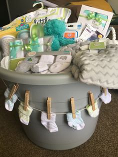 a baby's gift basket with socks, diapers and other items in it