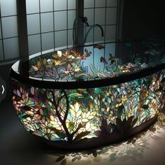 a glass bowl sink sitting on top of a counter next to a faucet