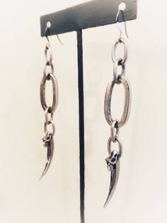 "Temporary August Shipping Delays. Orders may take 7-10 business days to ship. Chunky Raven Claw Earrings Chunky chain with cast raven claws on ear wires. lead free pewter Always ethically sourced bones. Nothing has ever been harmed for the purpose of our jewelry. All pieces are made-to-order despite the \"in stock\" number in the listing. Time frame varies from piece to piece so please message us if you need something by a certain date and we will do our best. A portion of our profits will be r Silver Dangle Grunge Jewelry, Silver Metal Jewelry With Claw Shape, Gothic Oxidized Metal Earrings, Nickel-free Metal Grunge Earrings, Gunmetal Dangle Earrings Metal Jewelry, Nickel-free Metal Earrings In Grunge Style, Gunmetal Dangle Earrings, Gunmetal Dangle Jewelry, Gunmetal Punk Metal Jewelry