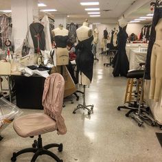 a room filled with lots of mannequins and dresses