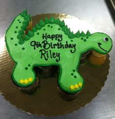 a birthday cake shaped like a dinosaur with the words happy birthday riley on it