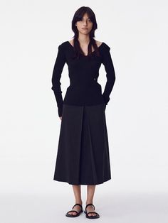 The Inverted Pleat Skirt is a beautifully tailored piece that showcases classic design with a modern twist. It features a high-waisted fit that accentuates the waistline, while the inverted pleats create a graceful, flowing movement. - This skirt is designed with a structured waistband to provide support and a seamless silhouette.- The inverted pleat detail not only adds an element of sophistication but also allows for a greater range of motion.- It's a versatile item that can be dressed up for formal occasions or paired down for a day at the office.- Meticulously stitched, the skirt holds its shape throughout the day, making it both stylish and practical for continuous wear. Modern Evening Pencil Skirt, Modern Full Skirt Fitted, Modern Fitted Full Skirt, Elegant Structured Lined Skirt, Fitted Flared Pleated Skirt For Formal Occasions, Fitted Full Pleated Skirt For Workwear, Elegant Tailored Pleated Skirt For Workwear, Chic Tailored Pleated Skirt, Elegant Asymmetrical Pleated Relaxed Skirt