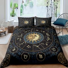 a bed covered in black and gold zodiac signs with numbers on the front, sitting next to a window