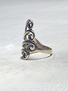 a silver ring sitting on top of a white surface