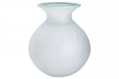 a white vase sitting on top of a table