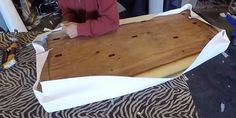 a woman is working on a piece of wood that has been cut into smaller pieces